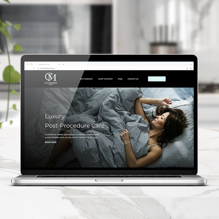 Cosmed website displayed on laptop